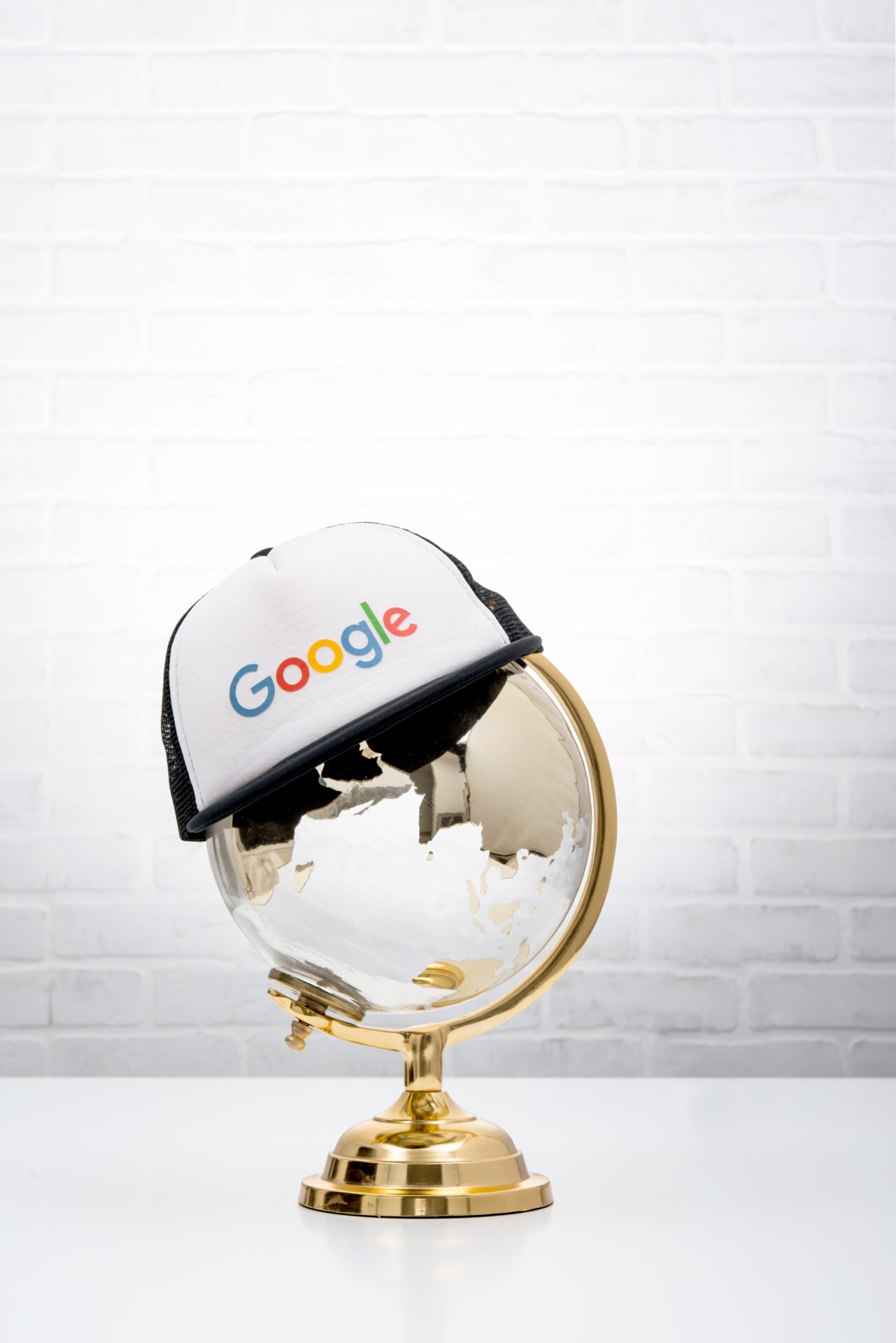 Branded hat resting on a globe